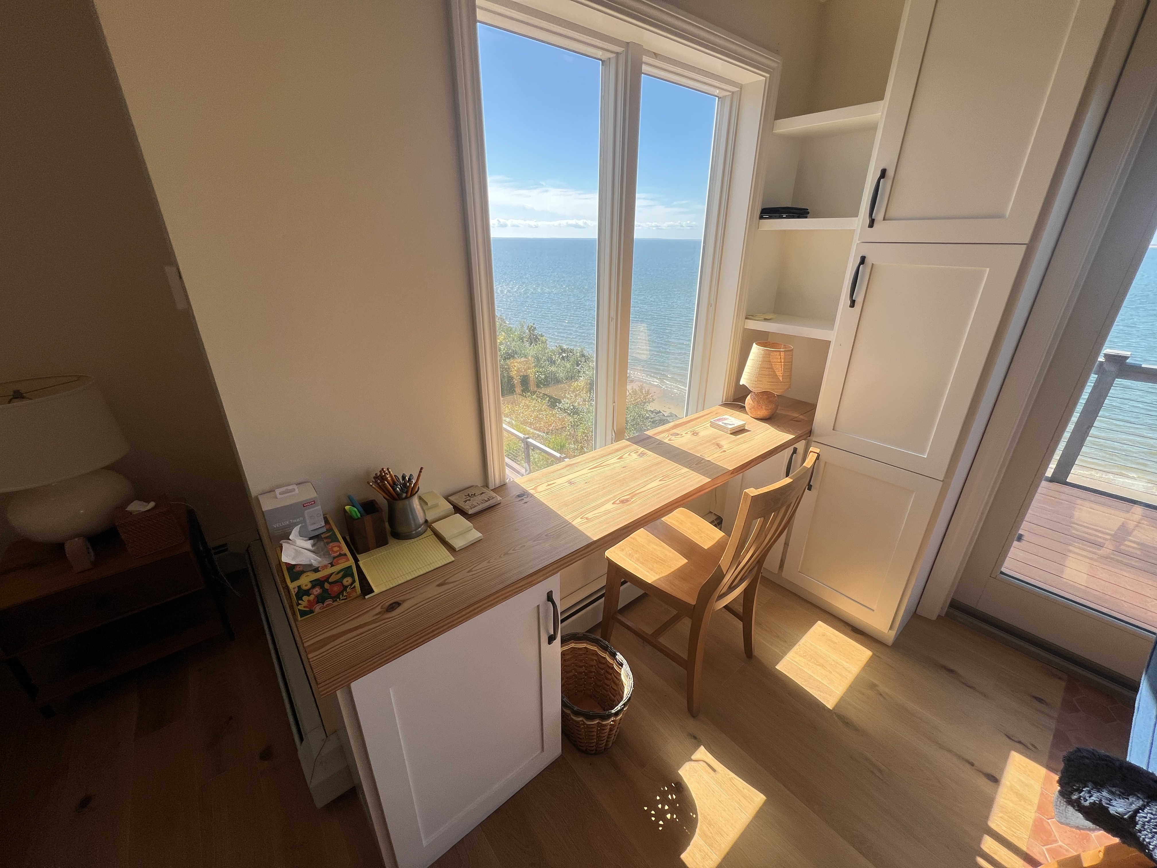 Custom window-side desk and built-in cabinetry.
