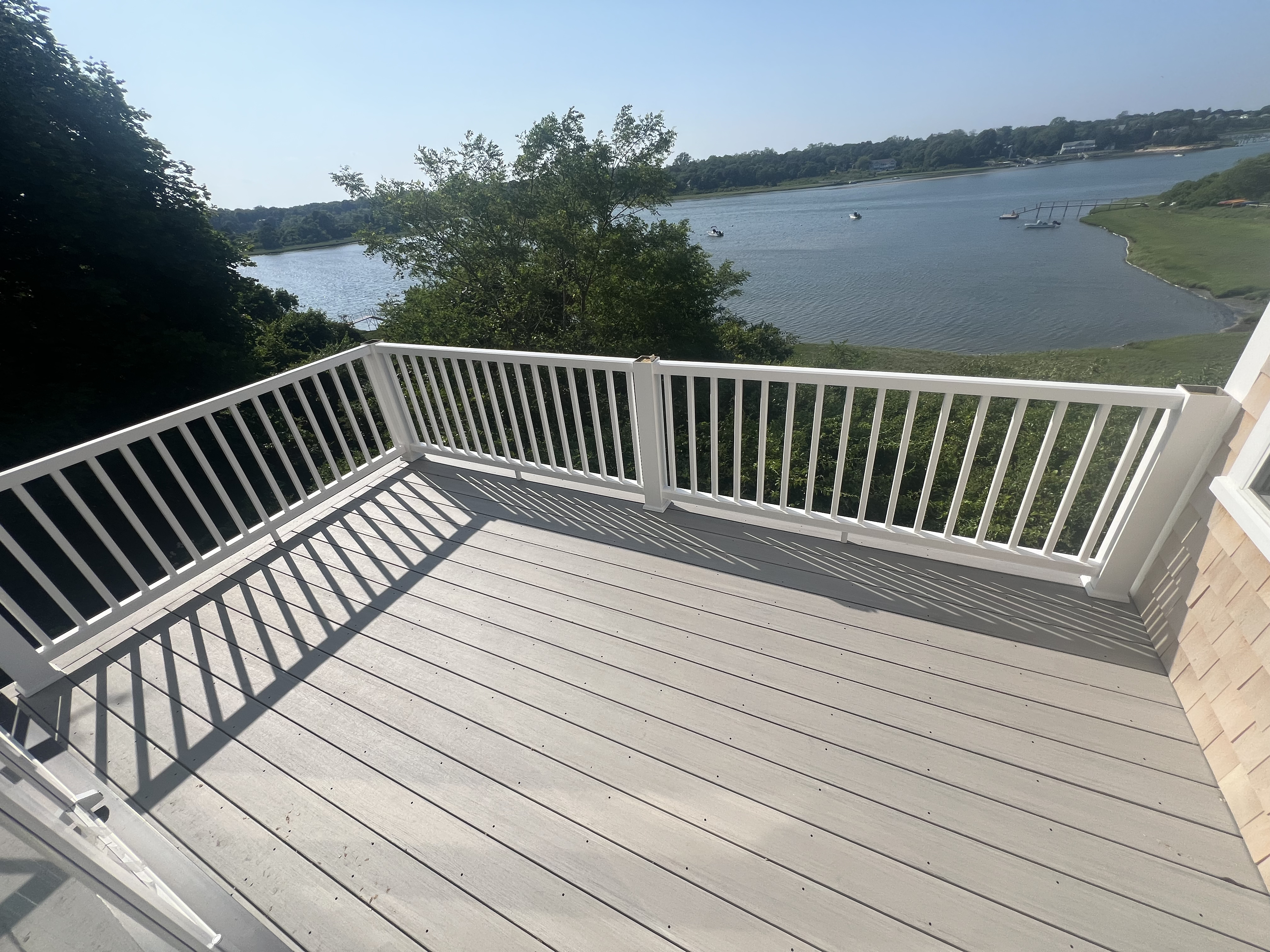 Decking and white railings overlooking the water.