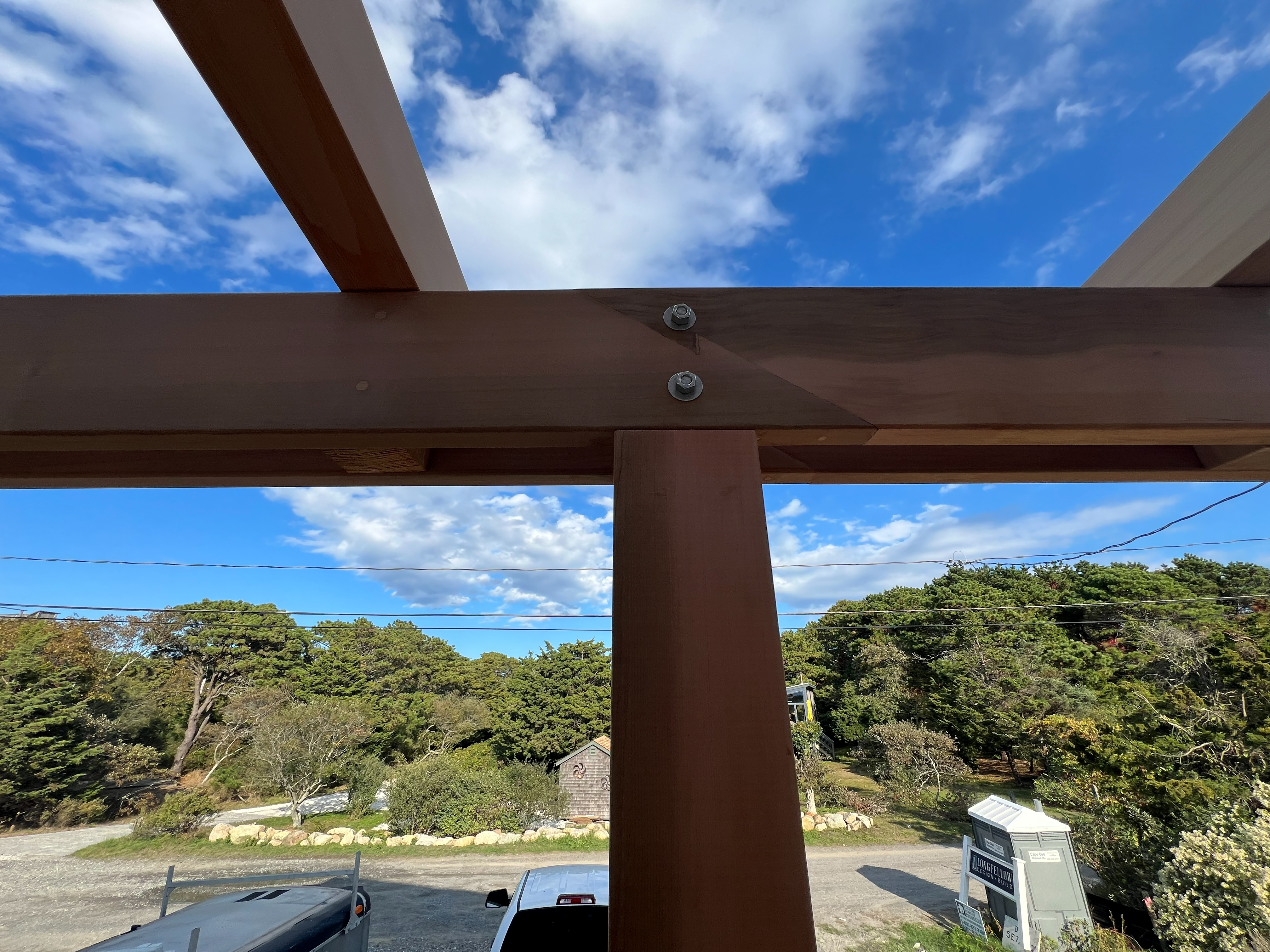 A close view of a pergola beam and post connection.
